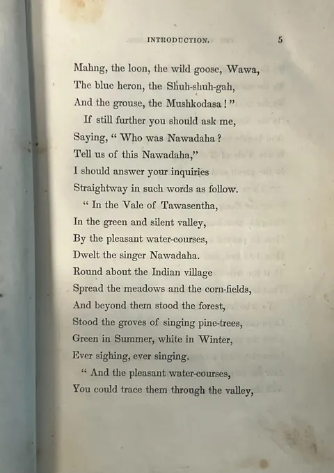 Page 5 of the Introduction to The Song of Hiawatha, containing the lines asking who was Nawadaha and answering that the singer Nawadaha dwelt in the Vale of Tawasentha