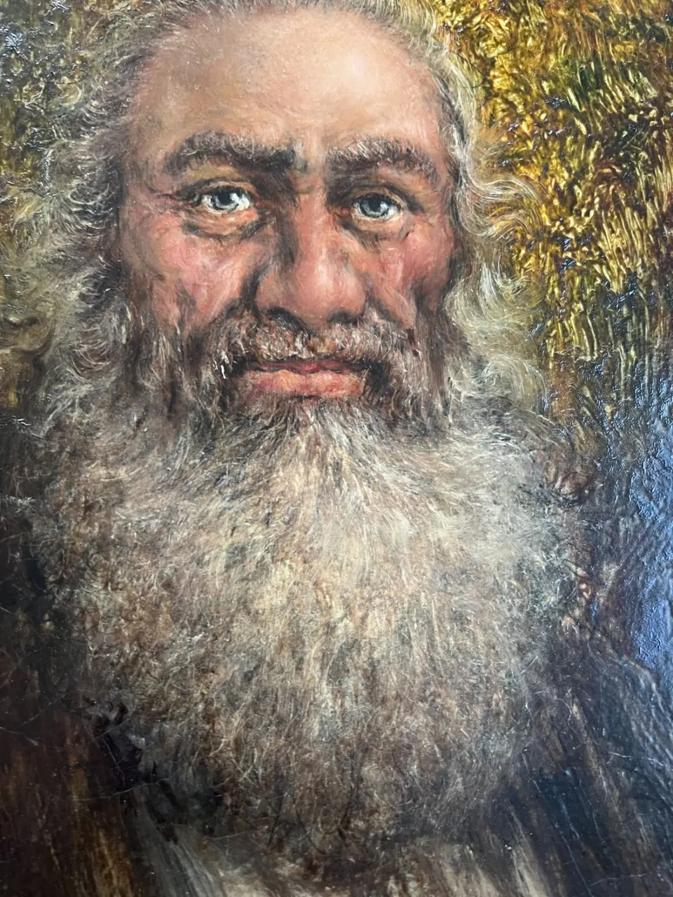 Original oil portrait of a bearded man in a lit frame