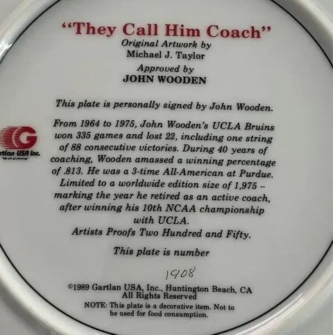 Back of the John Wooden collector plate showing the title, edition statement, and hand-numbered 1908